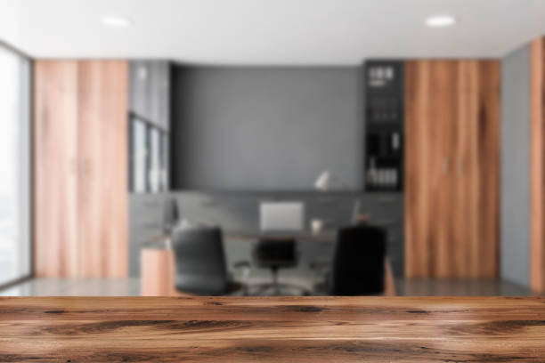 istock Table in blurry gray and wooden CEO office 1223998362
