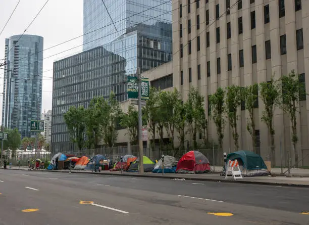 May 10, 2020  Homeless tents line Main Street in San Francisco's financial district during shelter in place order. Tents are surrounded by modern skyscrapers in an affluent area of the city.