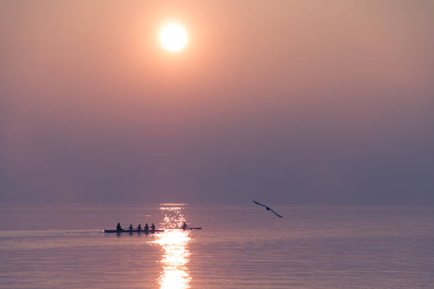A team of rowers practicing throught the bay of Gibraltar.