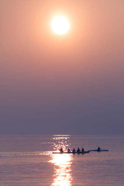 istock Rowing Team Training with Trainer over Shimmering Lake at Sunset 1224000794