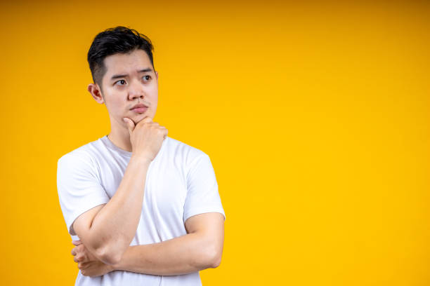 istock Young latin man isolated on yellow background looking sideways with doubtful and skeptical expression. 1224001157