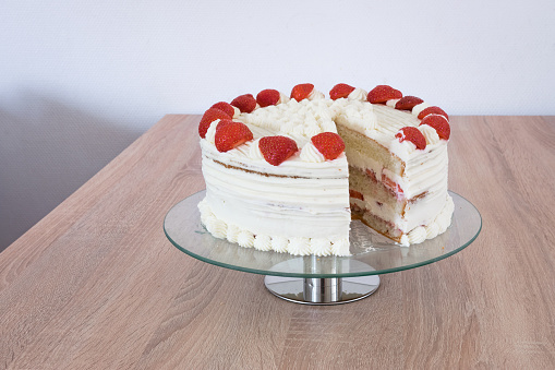 Mothers day cream cake decorated with whipped cream and strawberries.