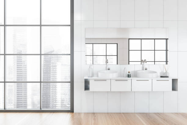istock Double sink in white bathroom with window 1224001534