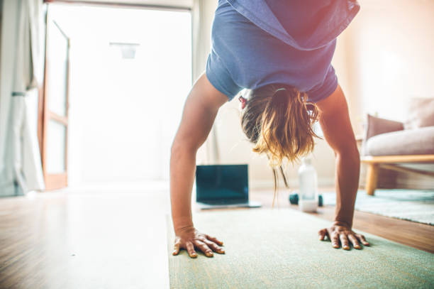 istock Young girl doing online exercise session at home arched back 1224002514