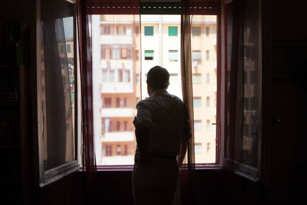 istock Man looking out of the window 1224002666