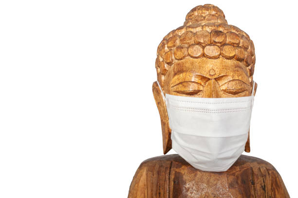 istock Buddha wooden statue wearing face mask 1224002680
