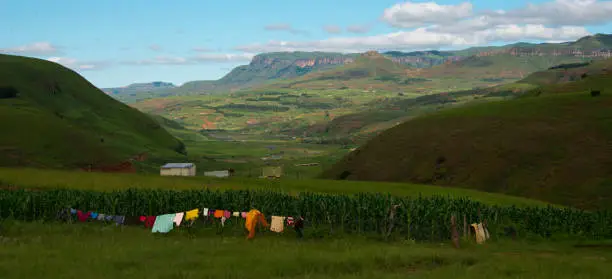 rural homestead with colorful clothesline in drakensberg mountains, kwazulu natal, south africa