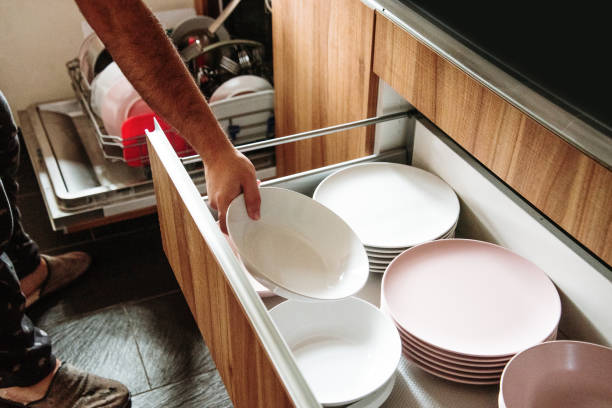 istock Arranging the dishes cleaned in the dishwasher 1224004416