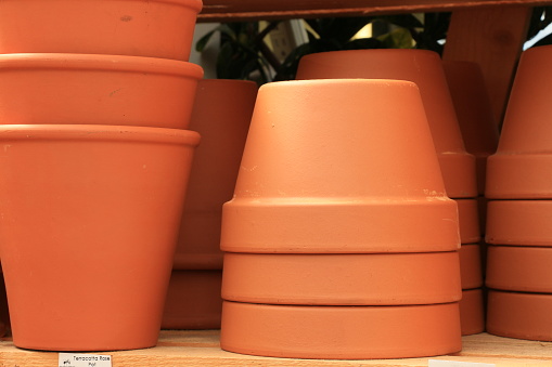 A horizontal image of stacked flowwer pots.