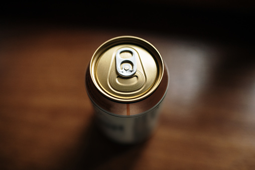 A detail of a gold colored beverage can
