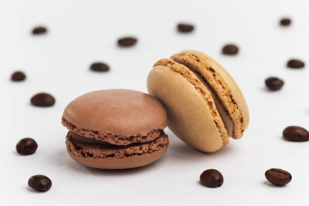 istock Brown and beige macarons on white background with coffee beans 1224009639