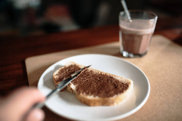 Spreading chocolate cream on a toast