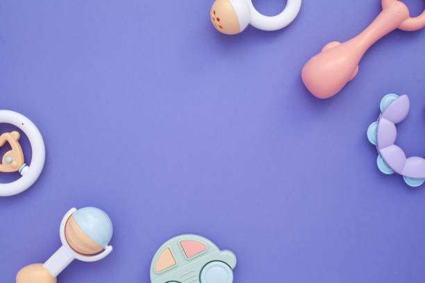 istock Flat lay composition with baby rattles set in pastel colors and space for text on lilac background. 1224010633