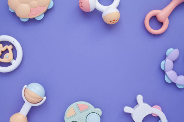 istock Flat lay composition with baby rattles set in pastel colors and space for text on lilac background. 1224010713