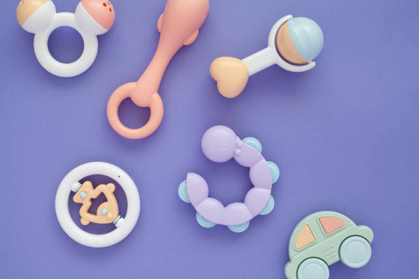 istock Flat lay composition with baby rattles set in pastel colors and space for text on lilac background. 1224010776