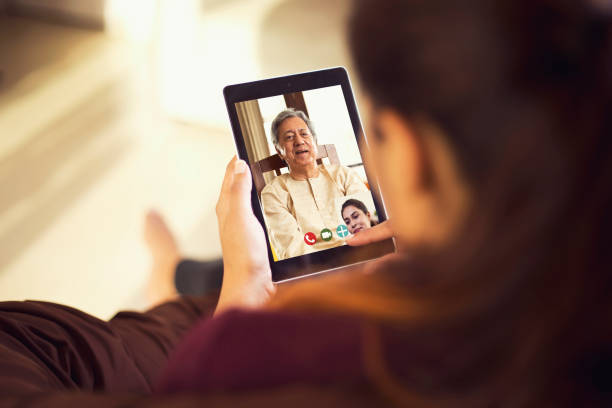 istock Daughter talking on video call with her father using digital tablet 1224011017