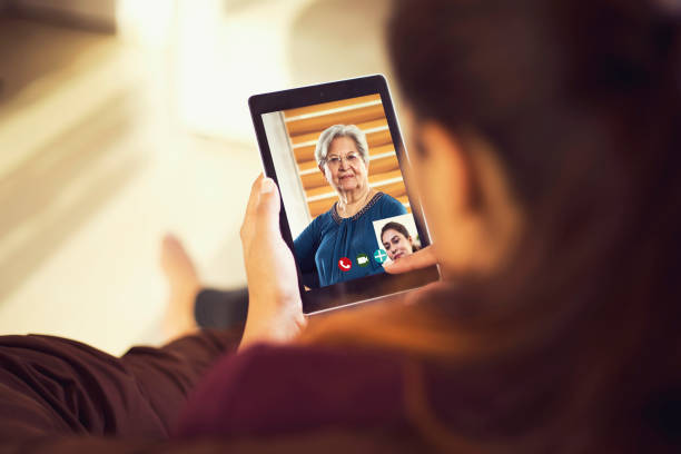 istock Daughter talking on video call with her mother using digital tablet 1224011075