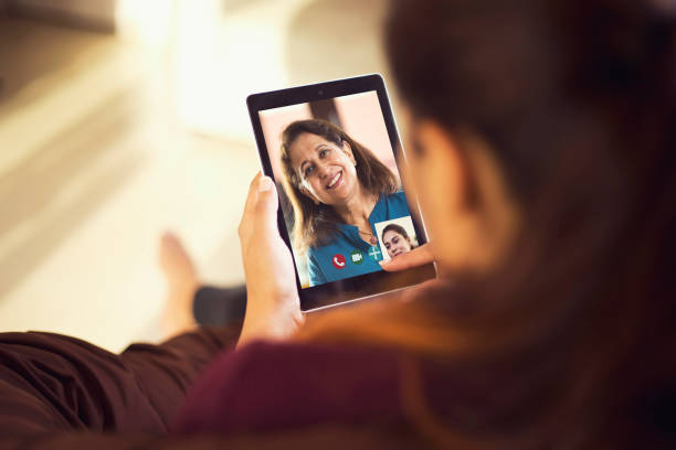 istock Daughter talking on video call with her mother using digital tablet 1224011098