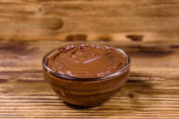istock Glass bowl with chocolate spread on a wooden table 1224011777