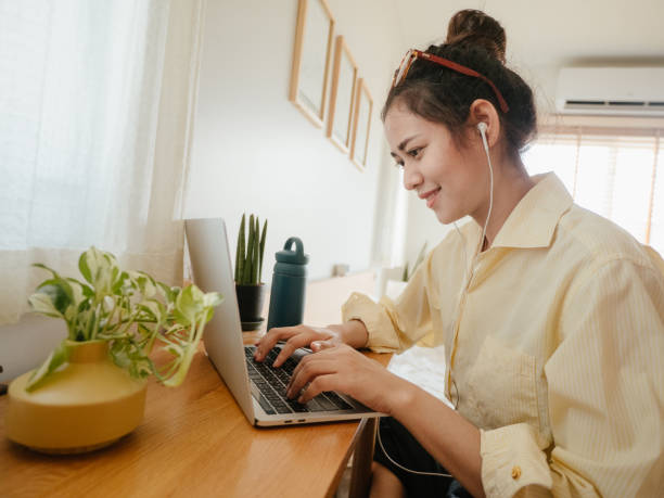 istock Asian woman using laptop during conference call at home. 1224011967