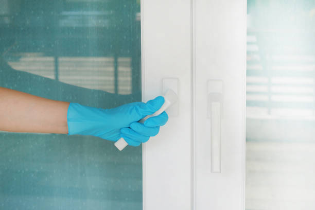 istock Hand wearing blue glove holding white door handle protecting allergic reaction or infectious diseases coronavirus/covid-19. 1224013442