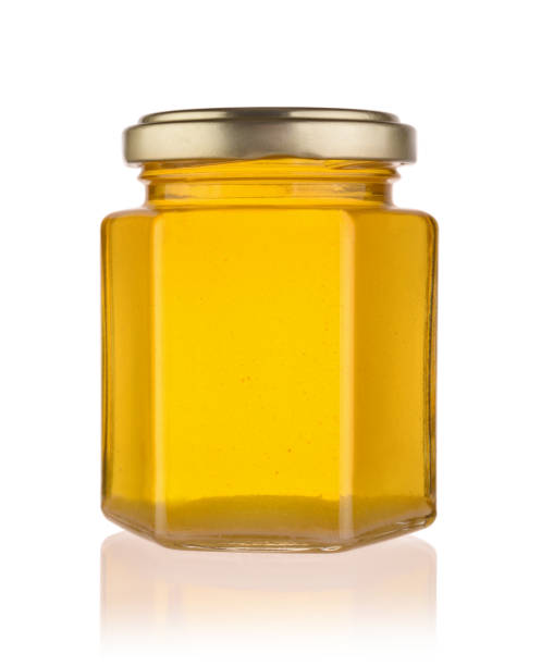 istock Fresh honey in a glass jar isolated. 1224013511