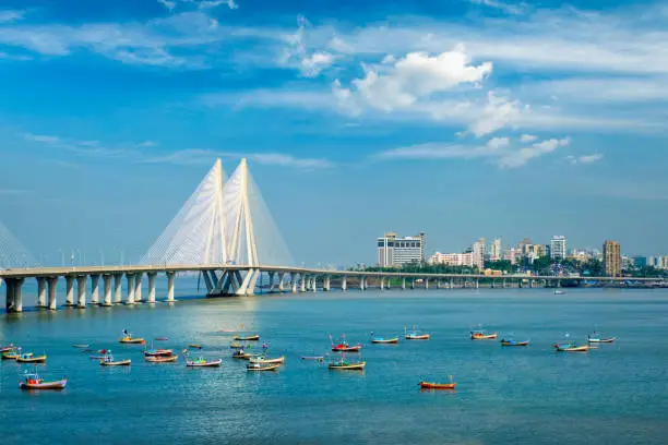 Photo of Bandra - Worli Sea Link bridge with fishing boats view from Bandra fort. Mumbai, India