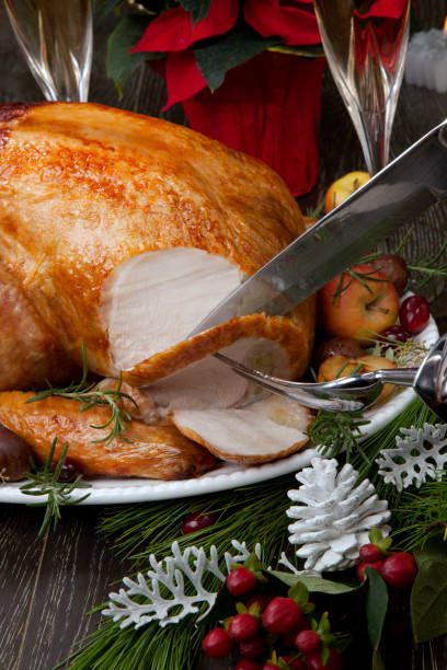 istock Carving Roasted Christmas Turkey with Grab Apples 1224016036