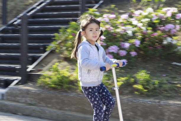 Japanese girl riding on a scooter (5 years old)