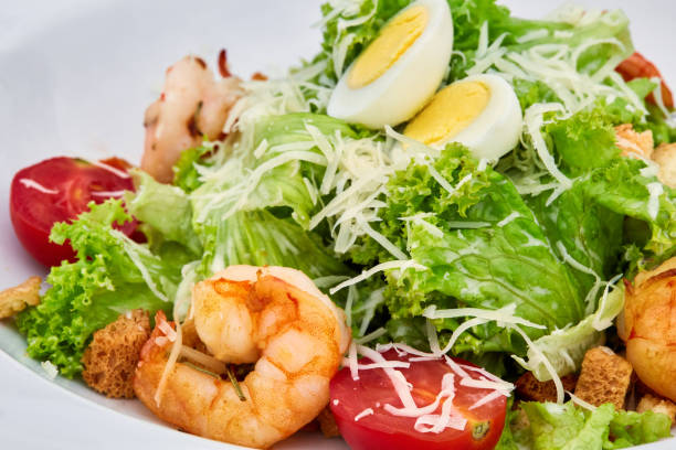 istock A plate of shrimp caesar salad on white plate 1224019386