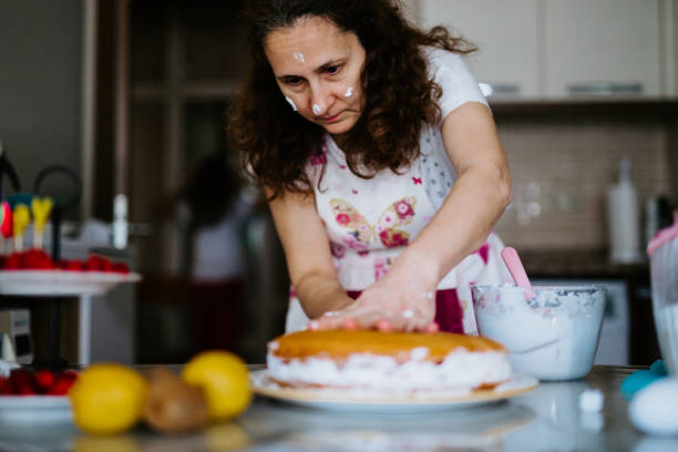 istock mother and daughter making cake 1224021524