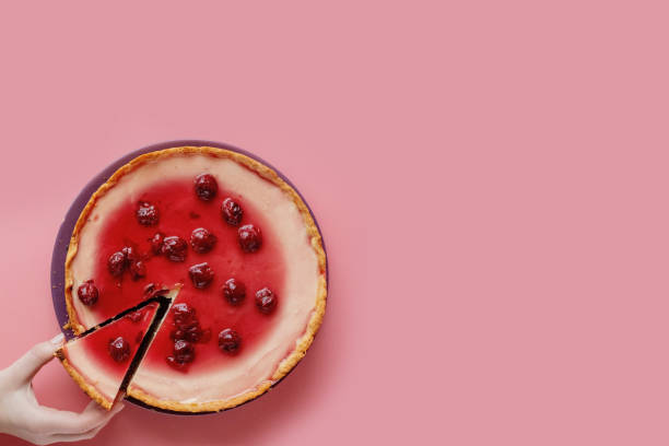 istock Slice of plain cheesecake with cranberry sauce on white plate decorated with mint leaf. Closeup view 1224023247