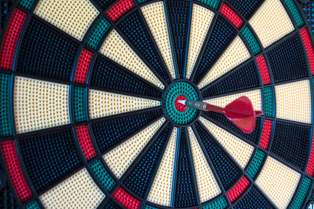 istock Dartboard with hit bullseye hanging on wall 1224023493