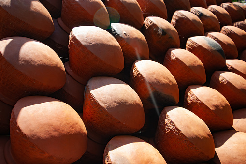 Rows of completed terracotta pots of urns being manufactured in remote Burmese village.