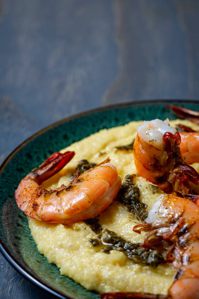 broiled shrimp over cheesy polenta. - grits prepared shrimp restaurant food imagens e fotografias de stock