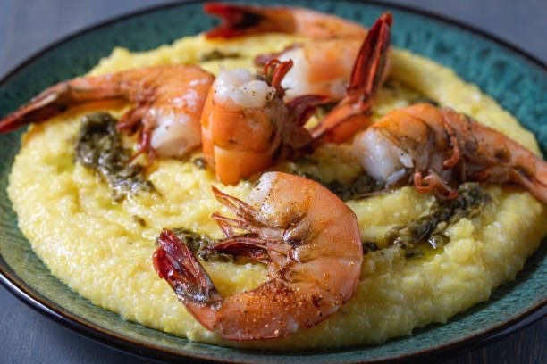 broiled shrimp over cheesy polenta. - grits prepared shrimp restaurant food imagens e fotografias de stock