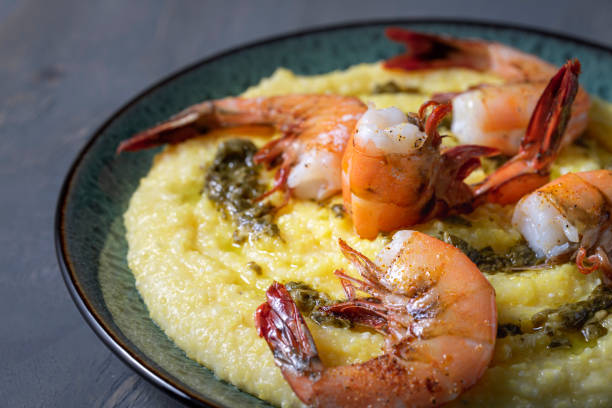 broiled shrimp over cheesy polenta. - grits prepared shrimp restaurant food imagens e fotografias de stock