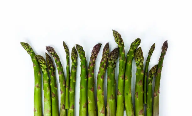 Bunch of fresh raw asparagus on white background, vegetarian concept. Green grass sparrowgrass sticks, food for veggie
