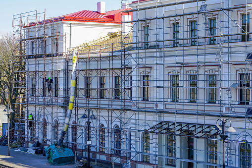 roof repair of a historic building, restoration and painting of the facade using scaffolding