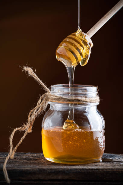 istock Honey drizzling. serving honey of a pot. 1224029995