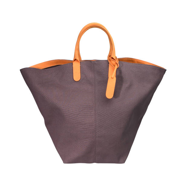 stilvolle stoff strandtasche isoliert auf weißem hintergrund - shopping bag orange bag handle stock-fotos und bilder