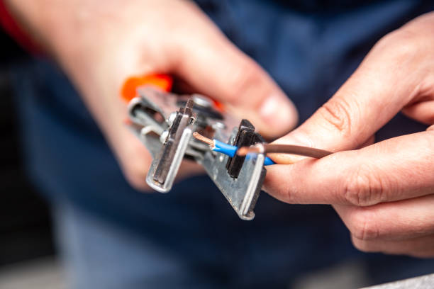 A man works with a wire stripper in his hands and a cable. Hands only. Horizontal orientation A man works with a wire stripper in his hands and a cable. Hands only. Horizontal orientation. High quality photo. wire cutter stock pictures, royalty-free photos & images