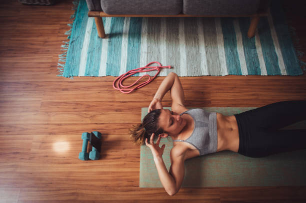 istock Sit-ups with mobile phone video call exercise hoime workout session copy space 1224031086