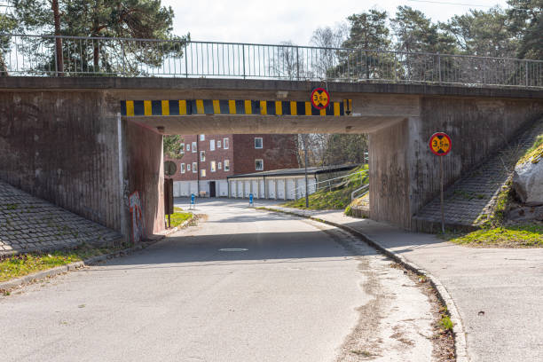istock Low tram bridge over a snall road in the suburbs.. 1224031552