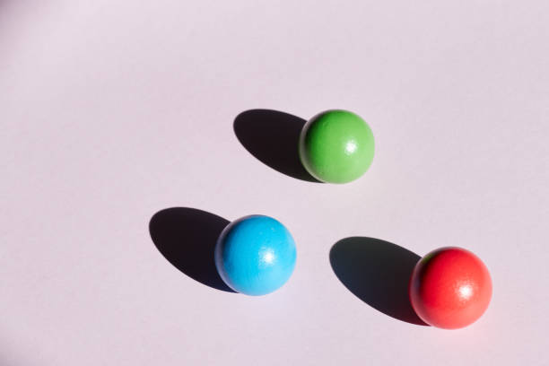 istock Three colored balls on a light background with hard shadows. abstract background for design. Copy space geometry 1224034092