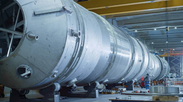istock Heavy Industry Manufacturing Facility / Factory where Large Diameter Pipe is Being Assembled. Modern Industrial Manufacturing Technology to Design and Construct Oil, Gas and Fuels Transport Pipeline. 1224034101