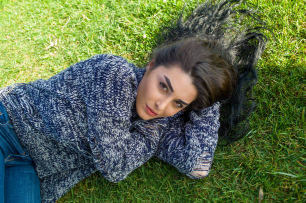 istock Woman lying on the grass 1224034788