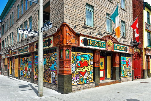 Ottawa, Canada - May 3, 2020: The popular bar The Heart and Crown is boarded up during the COVID-19 lockdown measures but commissioned local artist Falldown to paint temporary murals on the boards to make the place look better.