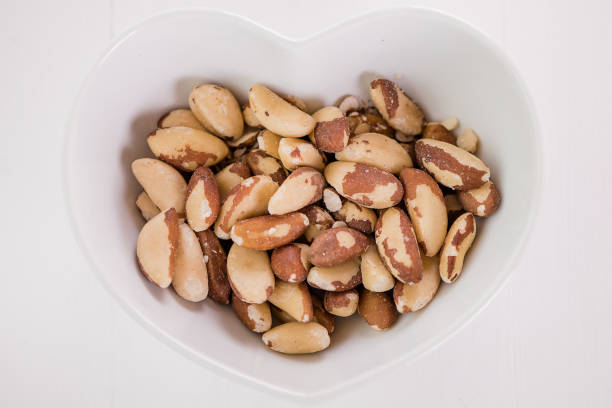 istock brasil nuts in white heart shape bowl 1224038975
