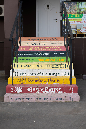 Moscow, Russia - March 22, 2020: A multi-colored staircase at the English language school. On the steps are written Harry Potter, The Chronicles of Narnia, Game of Thrones, The Lord of the Rings
